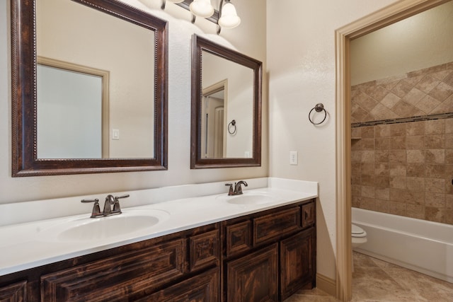 689 Barringer Ct, Fate, TX 75087 - bathroom featuring double vanity, toilet, and tub / shower combination