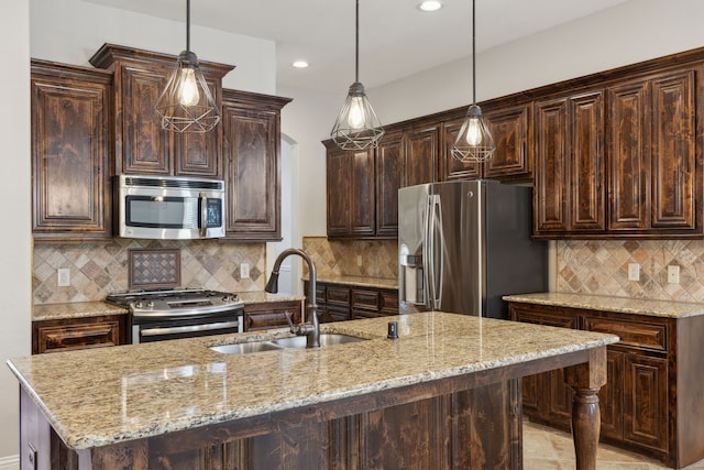 689 Barringer Ct, Fate, TX 75087 - kitchen with appliances with stainless steel finishes, a sink, dark brown cabinetry, light stone counters, and recessed lighting