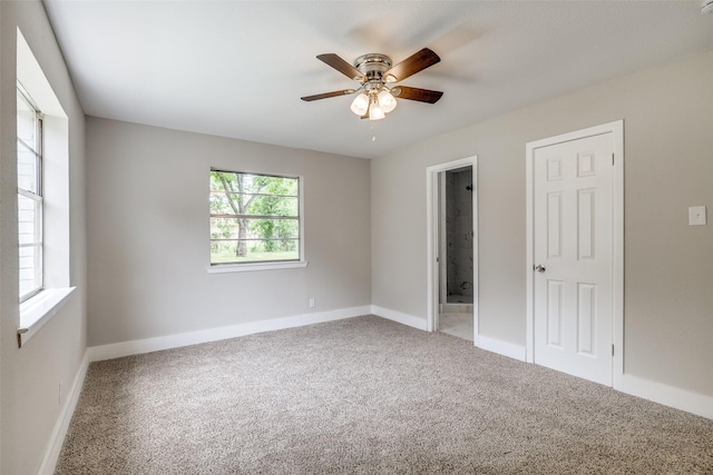 324 Deer Creek Rd, Everman, TX 76140 - unfurnished bedroom with carpet floors, baseboards, connected bathroom, and a ceiling fan
