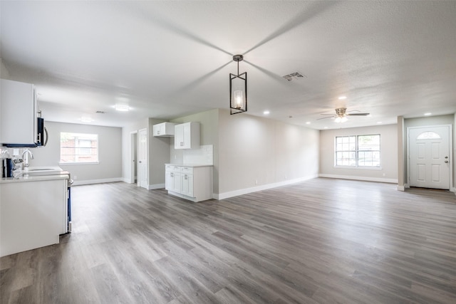 324 Deer Creek Rd, Everman, TX 76140 - unfurnished living room with a ceiling fan, baseboards, wood finished floors, and recessed lighting