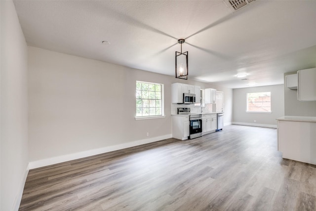 324 Deer Creek Rd, Everman, TX 76140 - unfurnished living room with light wood-style floors and baseboards