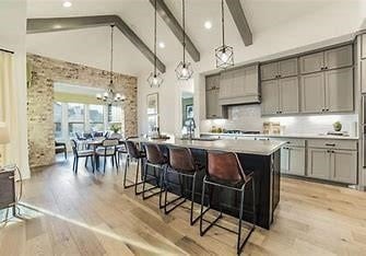 5924 Carmona Trl, Fort Worth, TX 76123 - kitchen with gray cabinetry, beamed ceiling, light wood finished floors, a breakfast bar area, and a chandelier