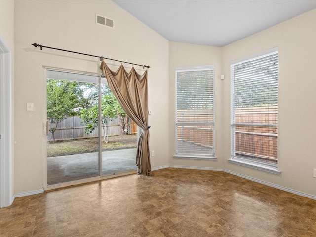 7404 Sunray Dr, Fort Worth, TX 76120 - unfurnished room with plenty of natural light, vaulted ceiling, baseboards, and tile patterned floors
