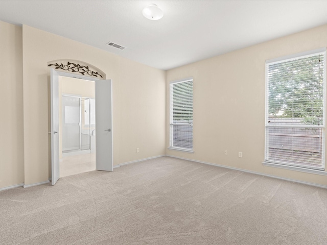 7404 Sunray Dr, Fort Worth, TX 76120 - empty room featuring light colored carpet, plenty of natural light, and baseboards