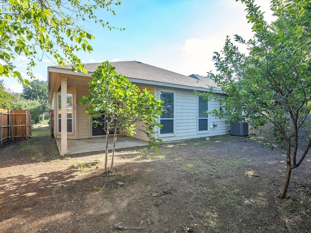 7404 Sunray Dr, Fort Worth, TX 76120 - back of house featuring fence, a patio area, central AC, and roof with shingles