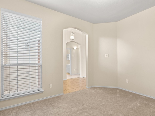 7404 Sunray Dr, Fort Worth, TX 76120 - carpeted spare room with arched walkways, baseboards, and tile patterned flooring