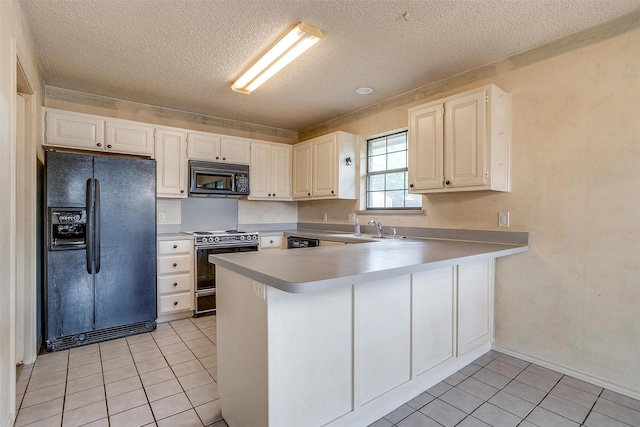 3941 Devonaire Dr, Fort Worth, TX 76008 - kitchen with black appliances, a textured ceiling, a peninsula, light tile patterned floors, and light countertops