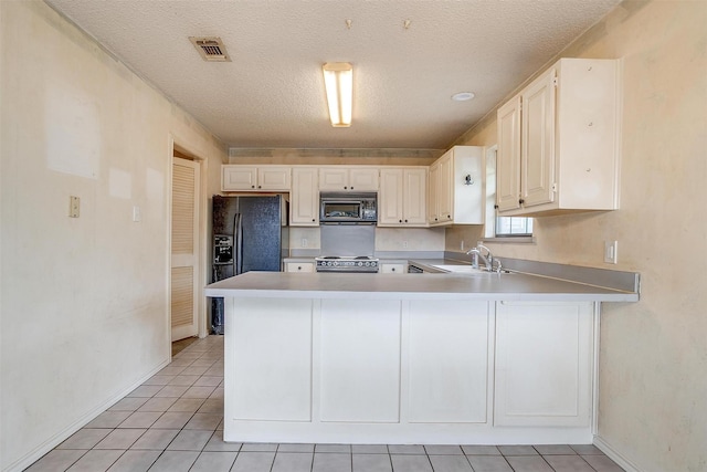 3941 Devonaire Dr, Fort Worth, TX 76008 - kitchen featuring black appliances, a sink, baseboards, light countertops, and a textured ceiling
