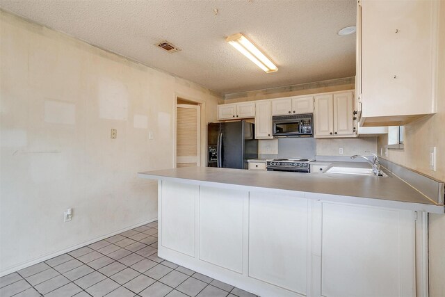 3941 Devonaire Dr, Fort Worth, TX 76008 - kitchen with black appliances, a sink, light countertops, a peninsula, and a textured ceiling
