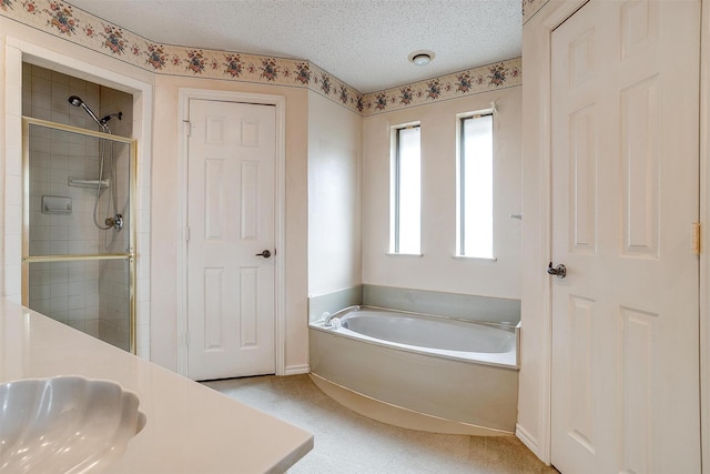 3941 Devonaire Dr, Fort Worth, TX 76008 - full bathroom with a shower stall, a bath, a sink, and a textured ceiling