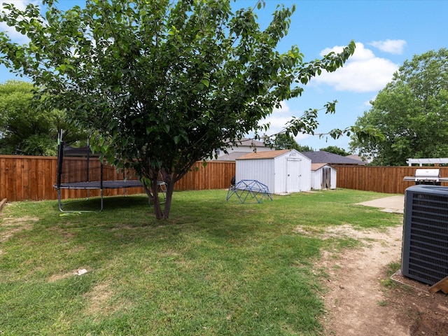 1429 Trading Post Dr, Fort Worth, TX 76131 - view of yard featuring a storage shed, a trampoline, cooling unit, and an outbuilding