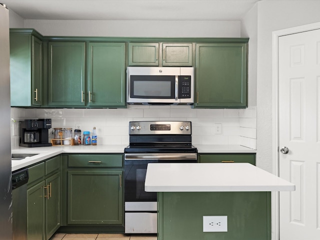 1429 Trading Post Dr, Fort Worth, TX 76131 - kitchen featuring green cabinets, stainless steel appliances, light countertops, and tasteful backsplash