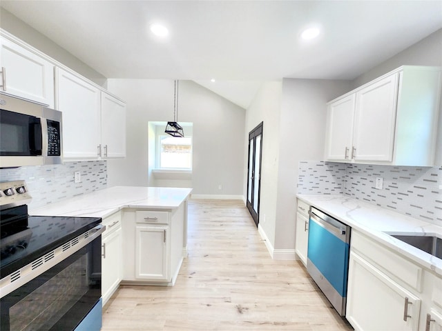 227 Rodeo Dr, Keller, TX 76248 - kitchen featuring stainless steel appliances, lofted ceiling, white cabinetry, light wood finished floors, and light stone counters