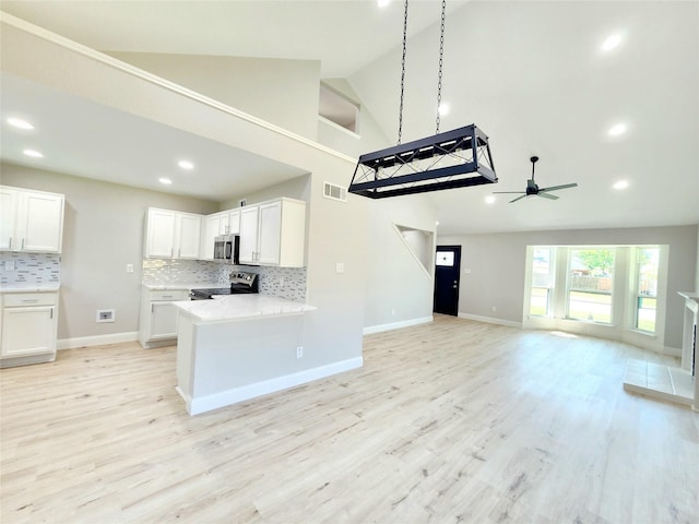 227 Rodeo Dr, Keller, TX 76248 - kitchen with appliances with stainless steel finishes, open floor plan, backsplash, light countertops, and ceiling fan