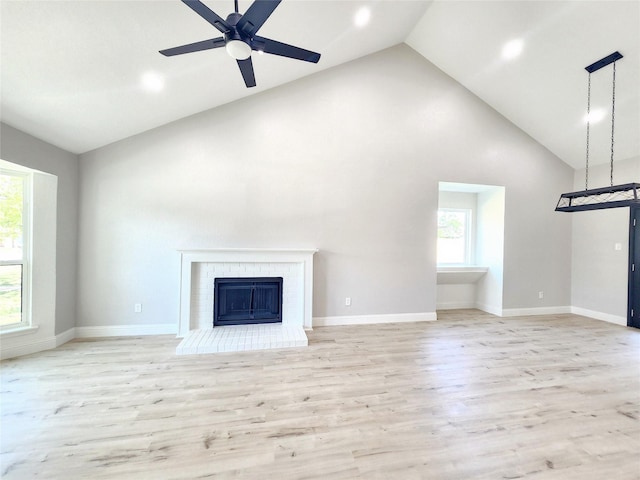 227 Rodeo Dr, Keller, TX 76248 - unfurnished living room with high vaulted ceiling, a brick fireplace, wood finished floors, ceiling fan, and recessed lighting
