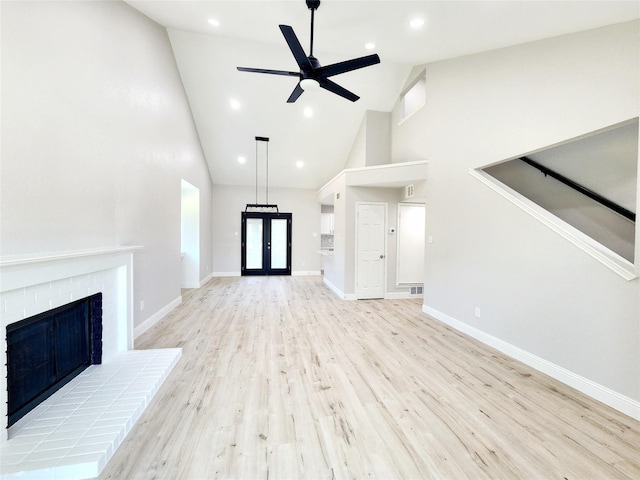 227 Rodeo Dr, Keller, TX 76248 - unfurnished living room featuring high vaulted ceiling, ceiling fan, light wood-type flooring, a fireplace, and baseboards