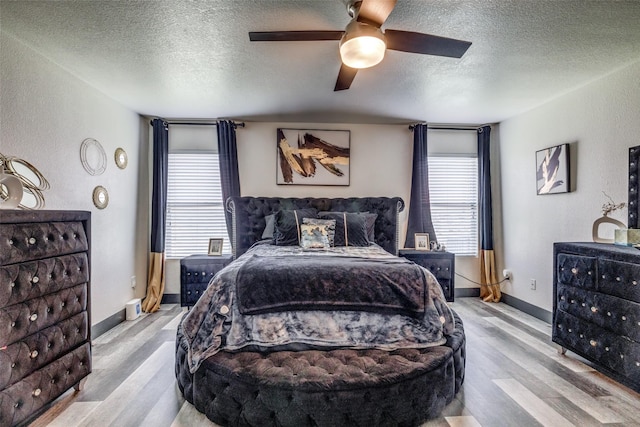 703 Moss Glen Trl, Arlington, TX 76002 - bedroom featuring a textured ceiling, wood finished floors, ceiling fan, baseboards, and a textured wall