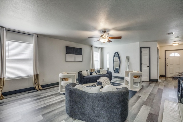 703 Moss Glen Trl, Arlington, TX 76002 - living area with baseboards, light wood finished floors, a textured ceiling, and ceiling fan