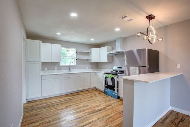 2189 Rs County Road 3150, Emory, TX 75440 - kitchen with stainless steel appliances, wall chimney exhaust hood, light wood finished floors, a sink, and light countertops