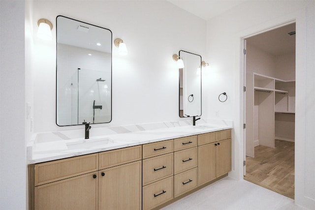2935 Lovers Ln, University Park, TX 75225 - full bathroom featuring a shower stall, double vanity, a walk in closet, and wood finished floors