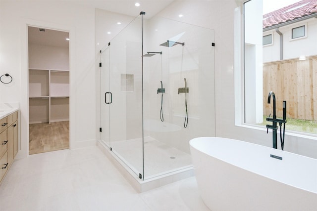 2935 Lovers Ln, University Park, TX 75225 - full bath with a shower stall, vanity, a soaking tub, recessed lighting, and a walk in closet