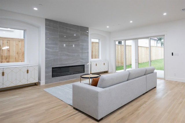 2935 Lovers Ln, University Park, TX 75225 - living room featuring light wood-type flooring, a large fireplace, recessed lighting, baseboards, and radiator