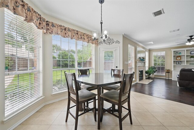 1500 Cool Springs Dr, Allen, TX 75013 - dining room featuring a chandelier, a fireplace with flush hearth, baseboards, light tile patterned floors, and a ceiling fan