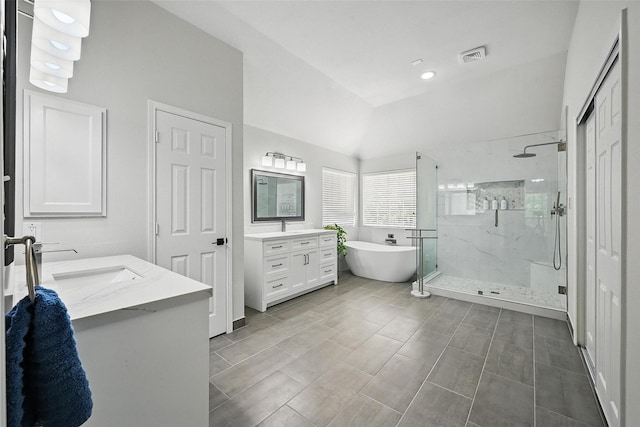 1500 Cool Springs Dr, Allen, TX 75013 - bathroom with vanity, a marble finish shower, a freestanding tub, and lofted ceiling