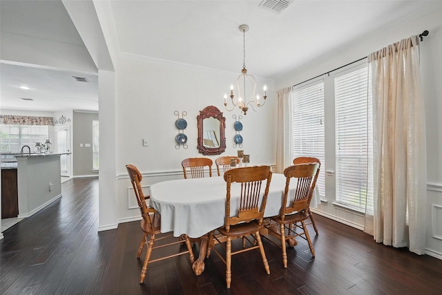 1500 Cool Springs Dr, Allen, TX 75013 - dining space featuring dark wood-type flooring, a chandelier, and ornamental molding