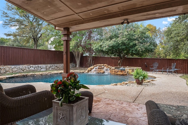 view of swimming pool featuring a fenced backyard, a patio area, and a hot tub