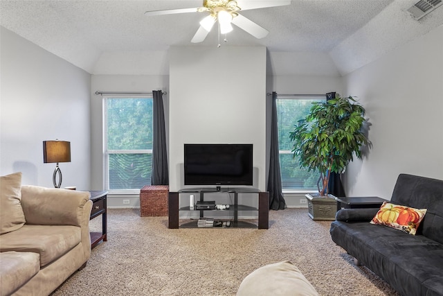 carpeted living room featuring lofted ceiling, a textured ceiling, healthy amount of natural light, and a ceiling fan
