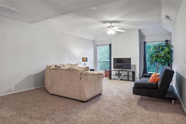 carpeted living area with a ceiling fan, a textured ceiling, vaulted ceiling, and baseboards
