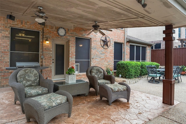 view of patio featuring a ceiling fan, outdoor dining area, and fence