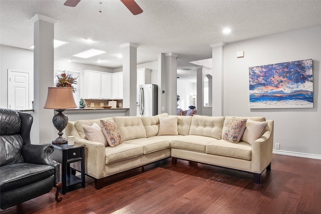 living room featuring dark wood-type flooring, a ceiling fan, a textured ceiling, baseboards, and recessed lighting