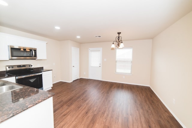 2105 Meadow View Dr, Princeton, TX 75407 - kitchen featuring appliances with stainless steel finishes, a chandelier, white cabinetry, wood finished floors, and recessed lighting