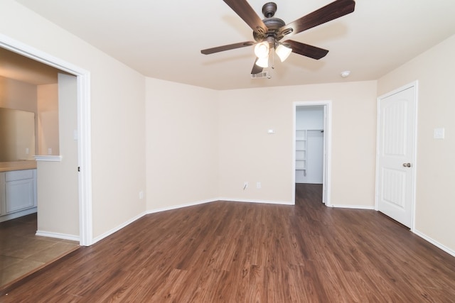 2105 Meadow View Dr, Princeton, TX 75407 - unfurnished bedroom featuring dark wood-style floors, a walk in closet, baseboards, a closet, and ceiling fan
