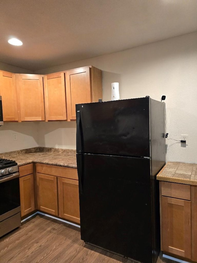 3915 Flory St, North Richland Hills, TX 76180 - kitchen with freestanding refrigerator, gas stove, dark wood-style flooring, and recessed lighting