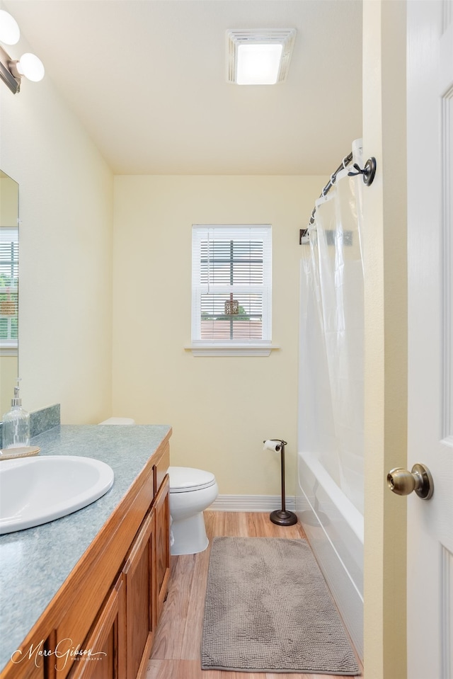 1170 163rd Hwy, Benton, LA 71006 - full bathroom with wood finished floors, vanity, toilet, shower / tub combo, and baseboards