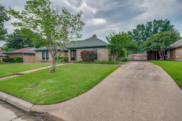 4312 High Spgs, Arlington, TX 76016 - view of front of home with brick siding, concrete driveway, a chimney, and a gate