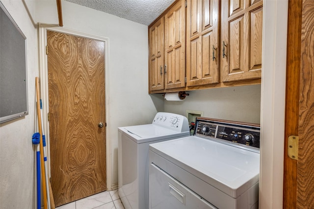 4312 High Spgs, Arlington, TX 76016 - laundry room with cabinet space, washing machine and dryer, a textured ceiling, and light tile patterned floors