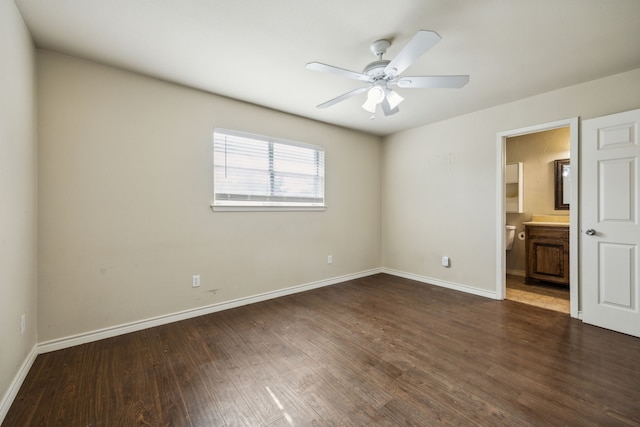 1003 N Washburn St, Decatur, TX 76234 - unfurnished bedroom with wood finished floors, baseboards, connected bathroom, and ceiling fan