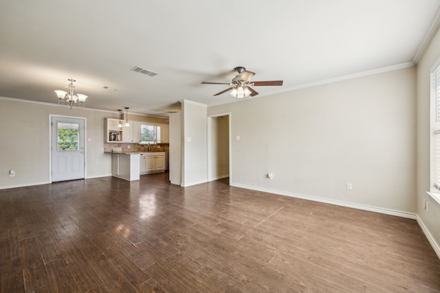 1003 N Washburn St, Decatur, TX 76234 - unfurnished living room with a chandelier, dark wood-type flooring, baseboards, a ceiling fan, and crown molding