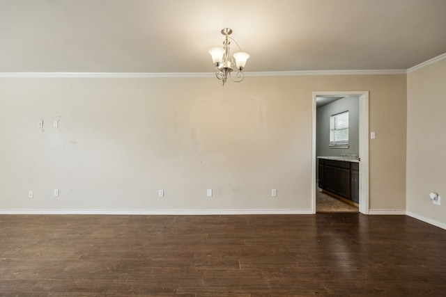 1003 N Washburn St, Decatur, TX 76234 - spare room with a chandelier, dark wood-style floors, baseboards, and ornamental molding
