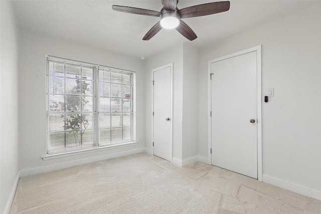 513 Edna Ct, Everman, TX 76140 - unfurnished bedroom with light carpet, multiple windows, and baseboards