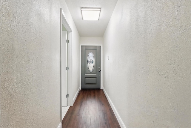 513 Edna Ct, Everman, TX 76140 - entryway with baseboards, dark wood-type flooring, and a textured wall