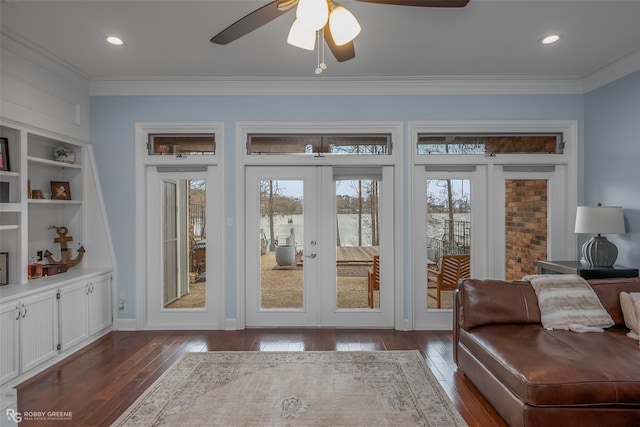 entryway with french doors, dark wood-type flooring, ornamental molding, ceiling fan, and built in features