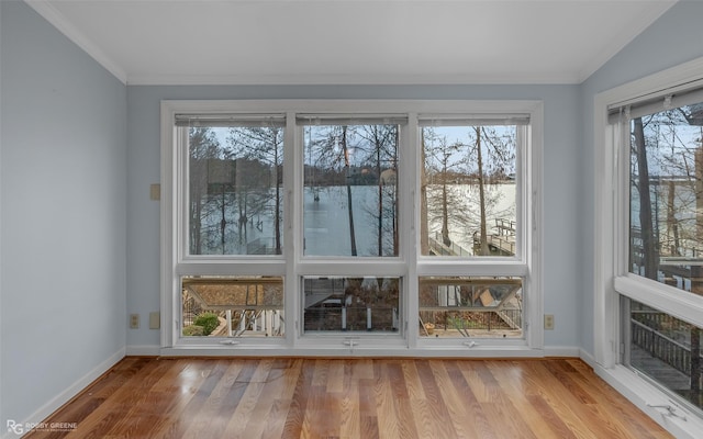 unfurnished sunroom with a water view