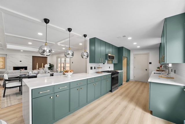 8338 Bocowood Dr, Dallas, TX 75228 - kitchen with appliances with stainless steel finishes, a sink, a peninsula, light wood-type flooring, and recessed lighting