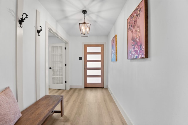 8338 Bocowood Dr, Dallas, TX 75228 - doorway to outside featuring light wood-type flooring, a chandelier, and baseboards