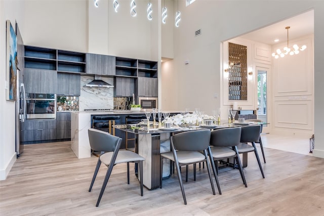 13554 Pyramid Dr, Farmers Branch, TX 75234 - dining space featuring light wood-style floors, a chandelier, and baseboards